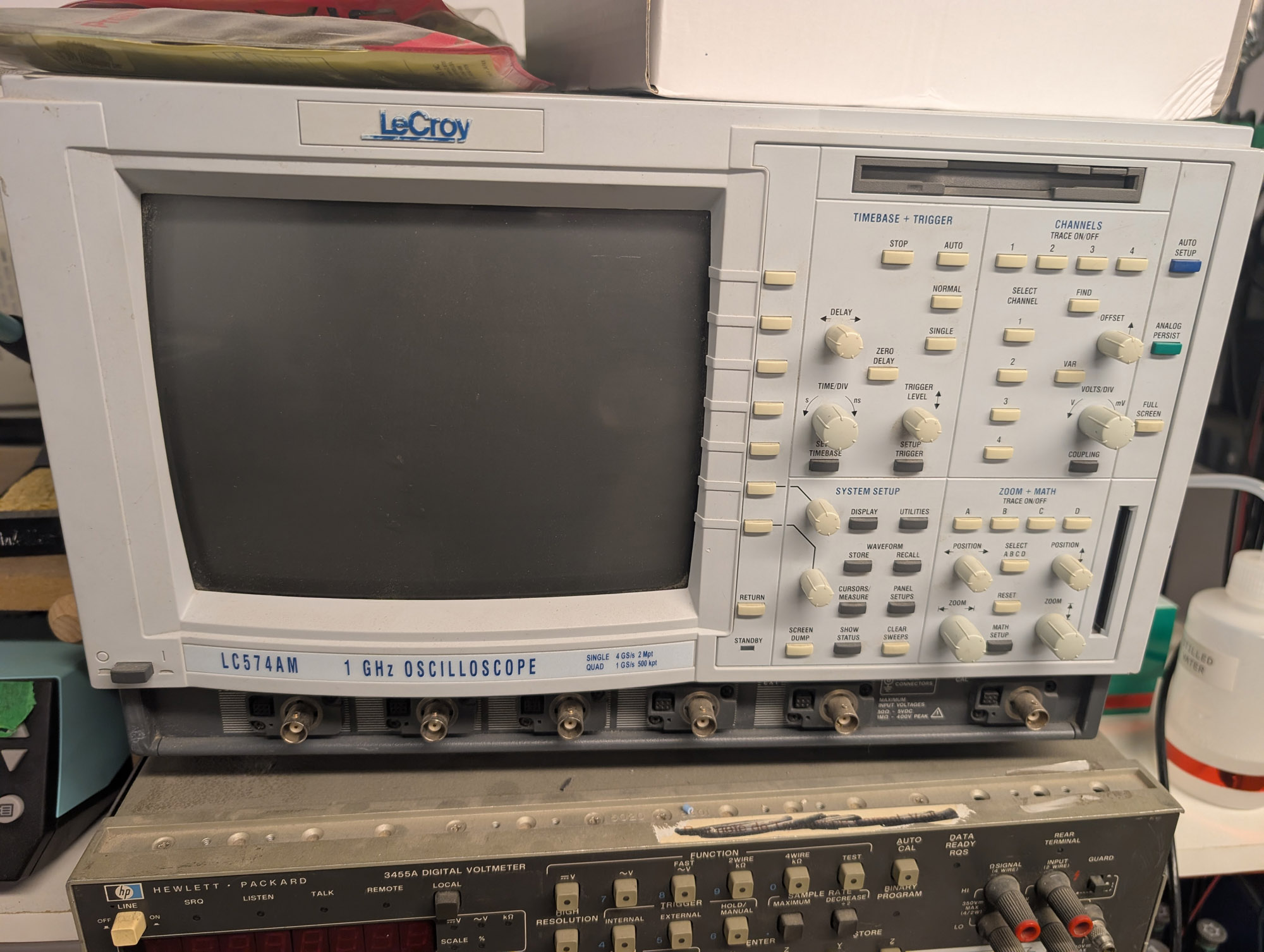A beige oscilloscope with a large CRT on it, with LeCroy at the top and LC574AM 1GHz Oscilloscope at the bottom. There is a floppy drive in the upper right, and an array of knobs and buttons under it